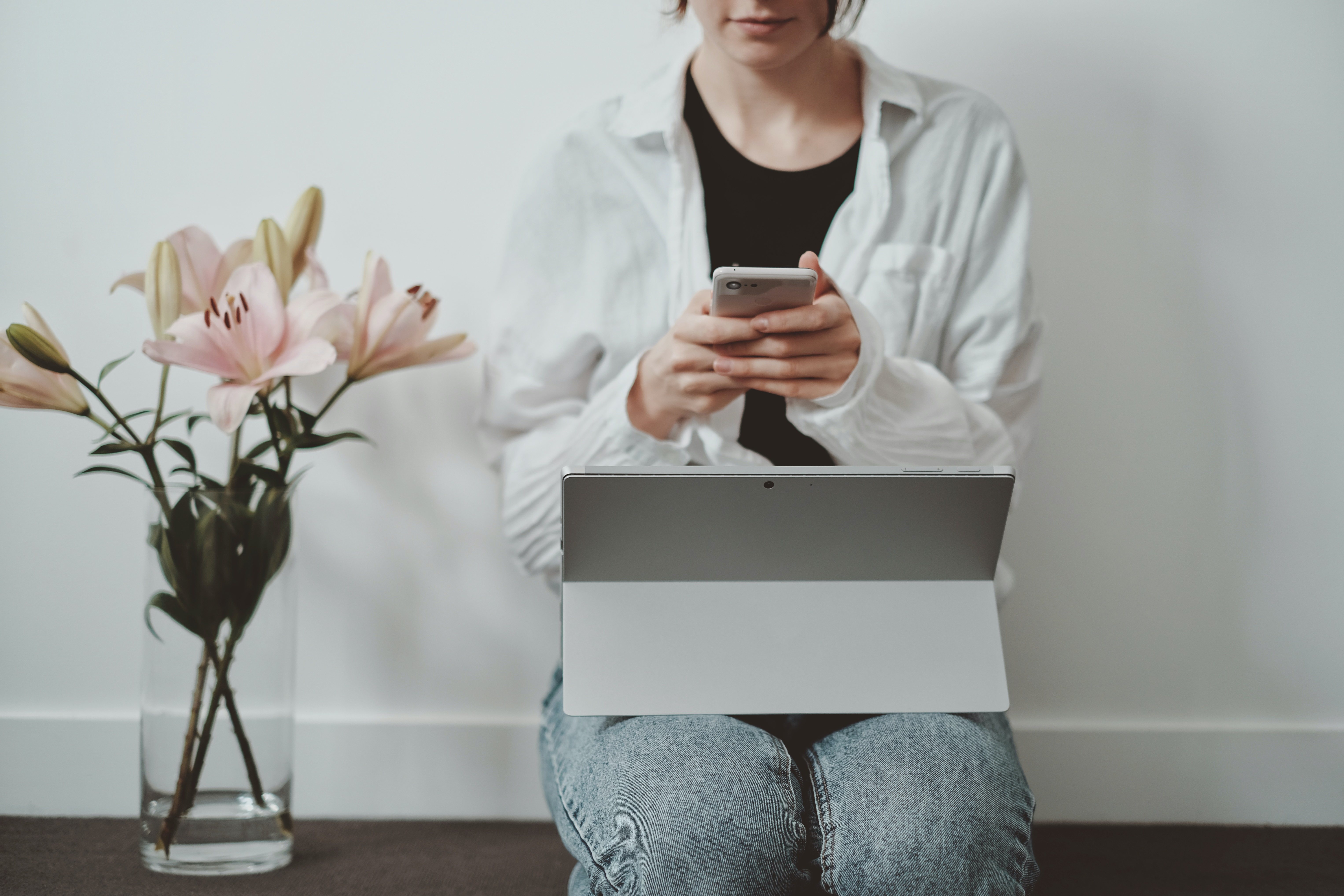 Canva   Woman On Smartphone Working On Tablet